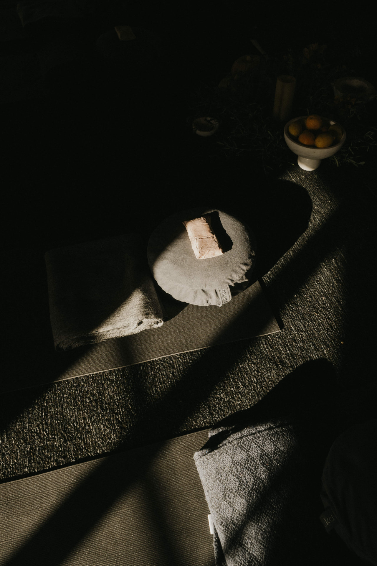 Yoga mat and bolster in morning light at a Kaer retreat