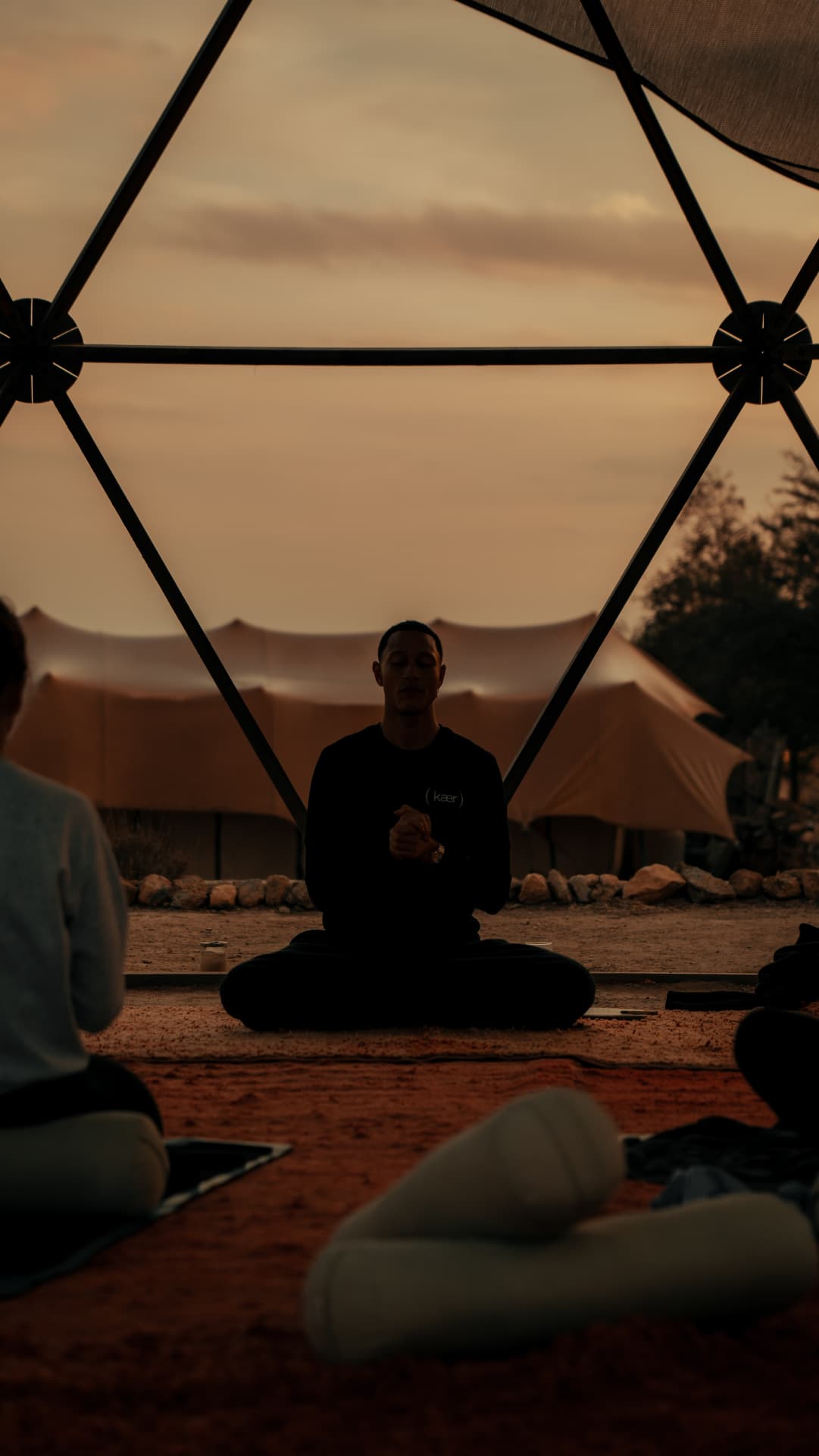 Meditation in a desert dome at dusk during a Kaer retreat