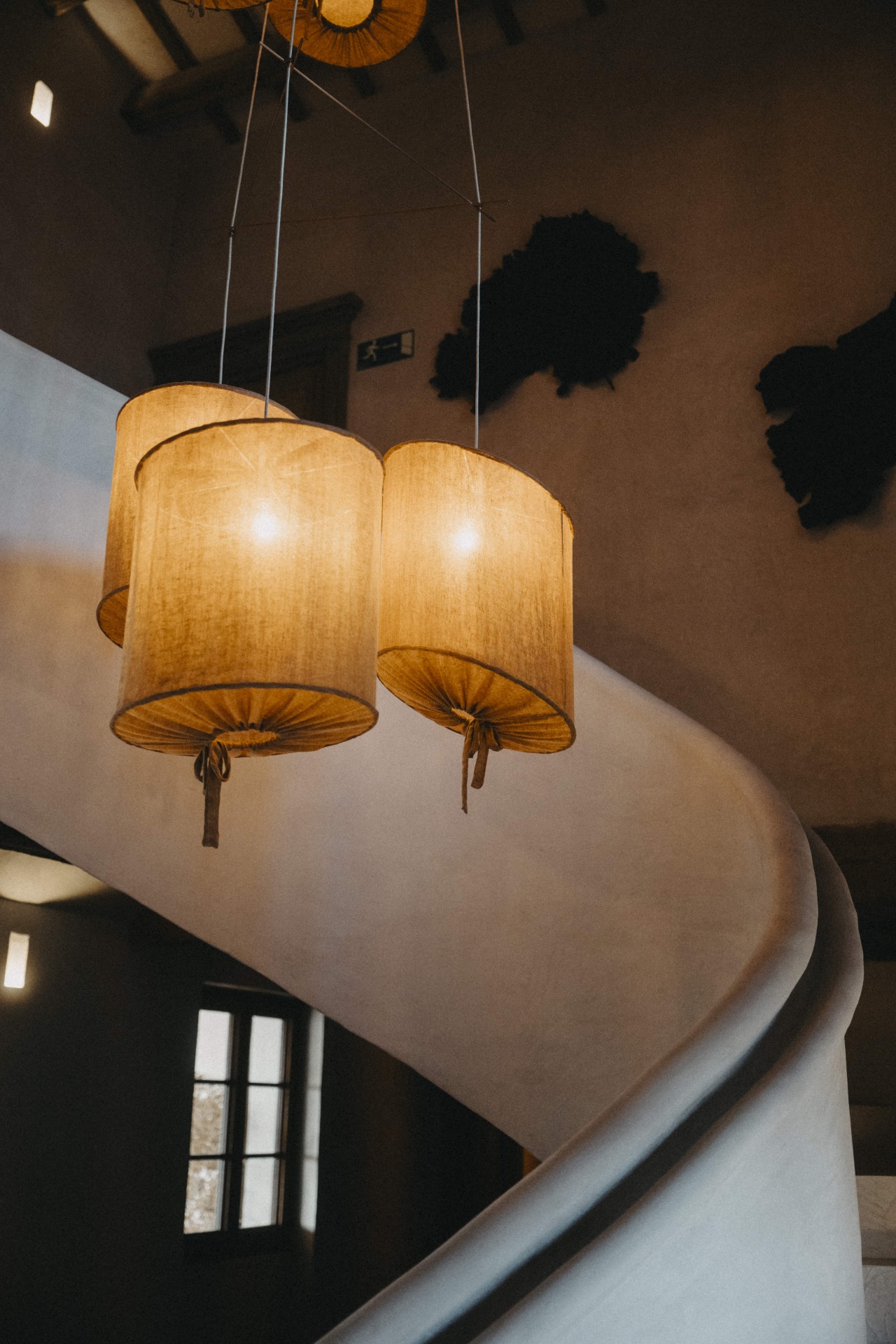 Warm interior lighting and sculptural staircase inside the Mallorca retreat villa